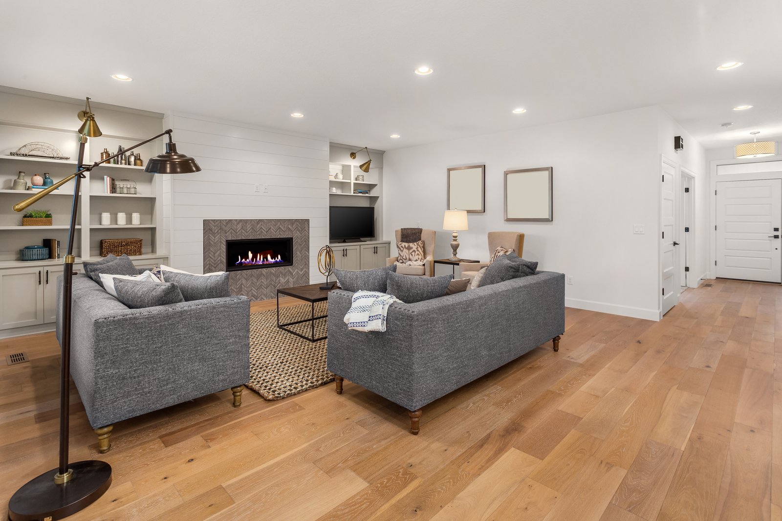 Sterling + Modern family room with fireplace by Reschka Design Build