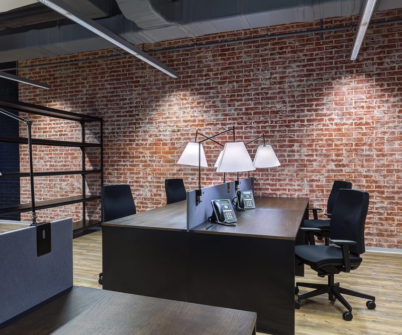 Urban + Workspace brick wall and desk by Reschka Design Build