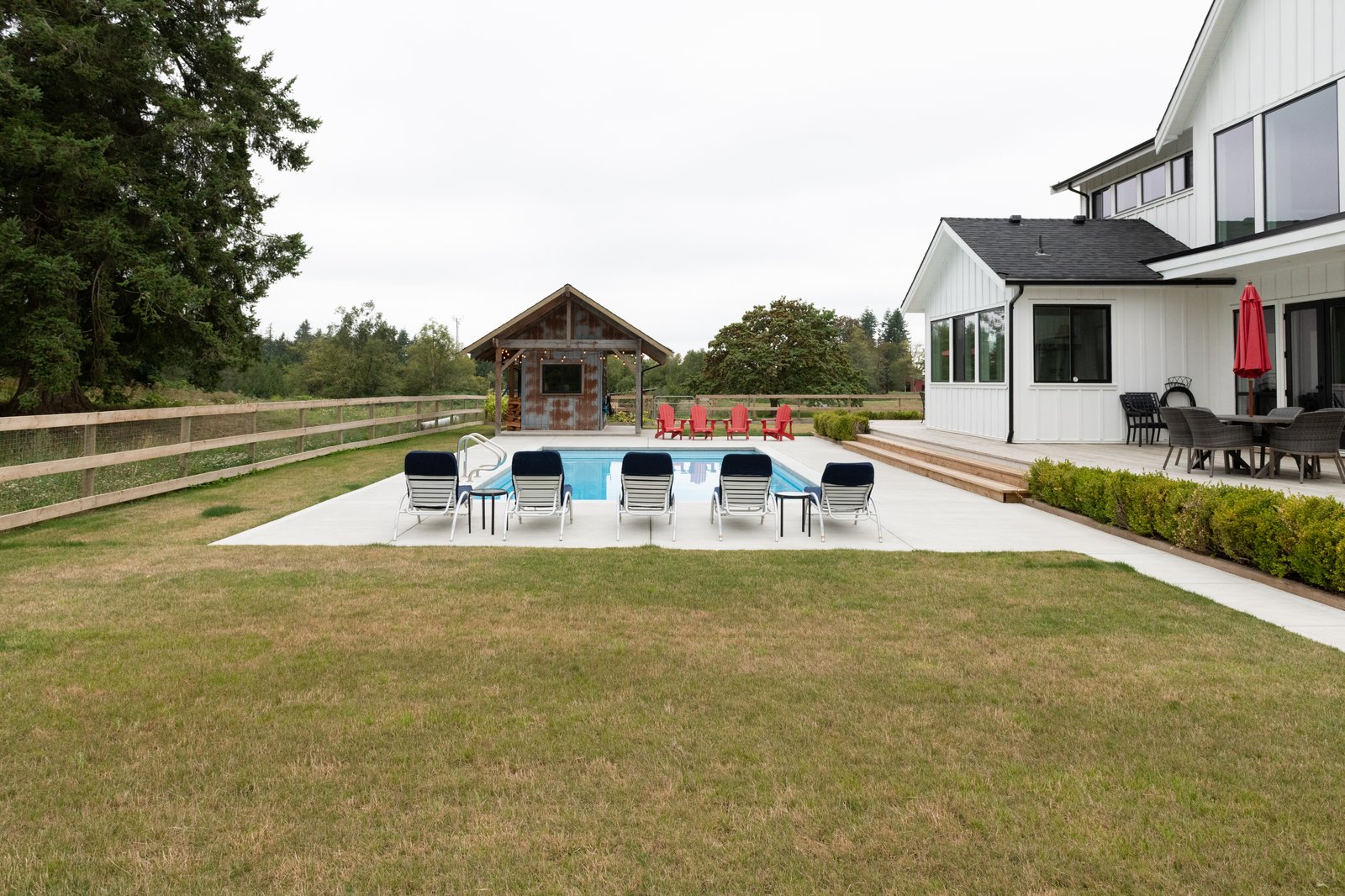 Willow Ridge + Estate pool house backyard view by Reschka Design Build