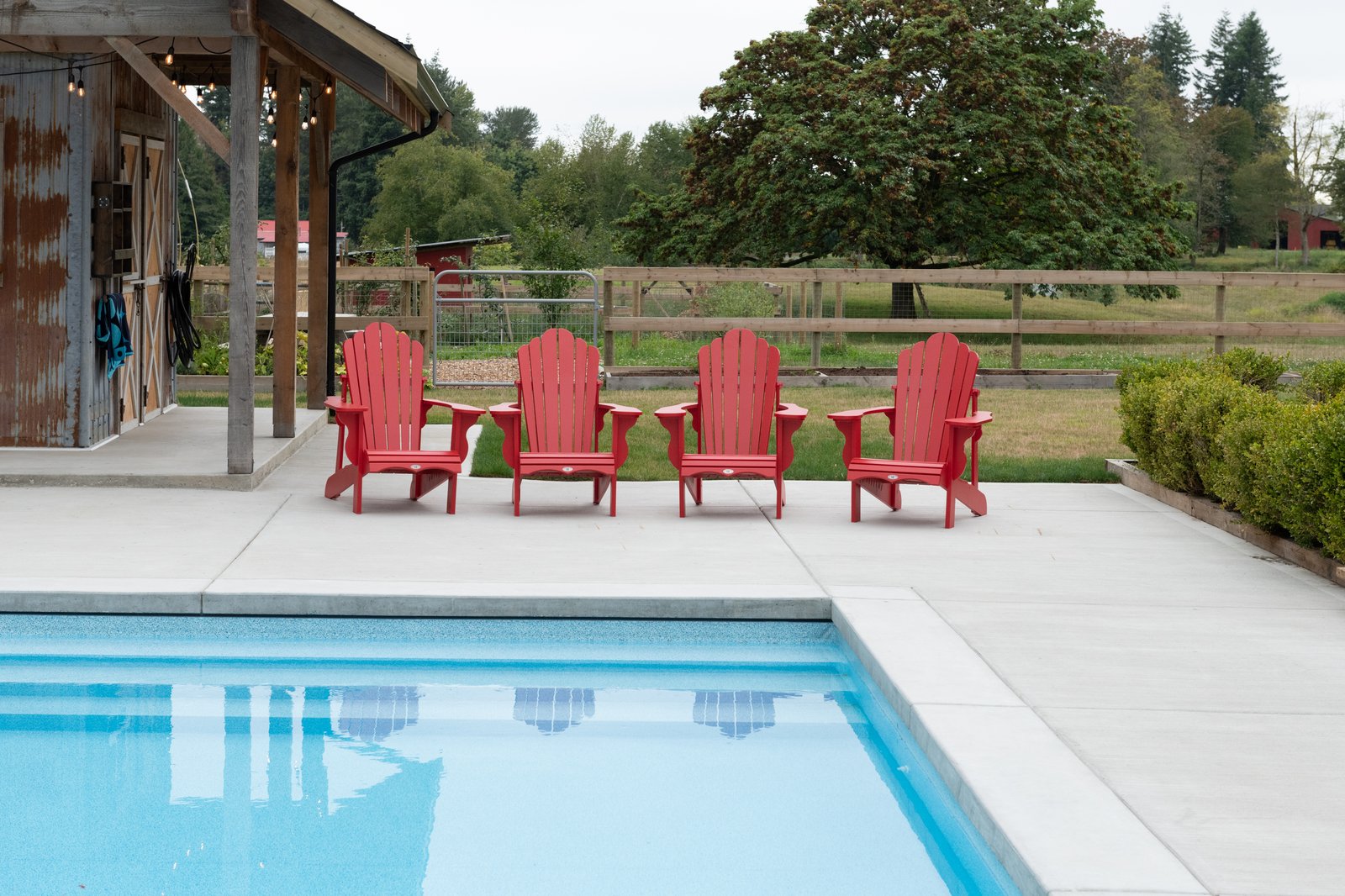 Willow Ridge + Estate poolside with barn view by Reschka Design Build